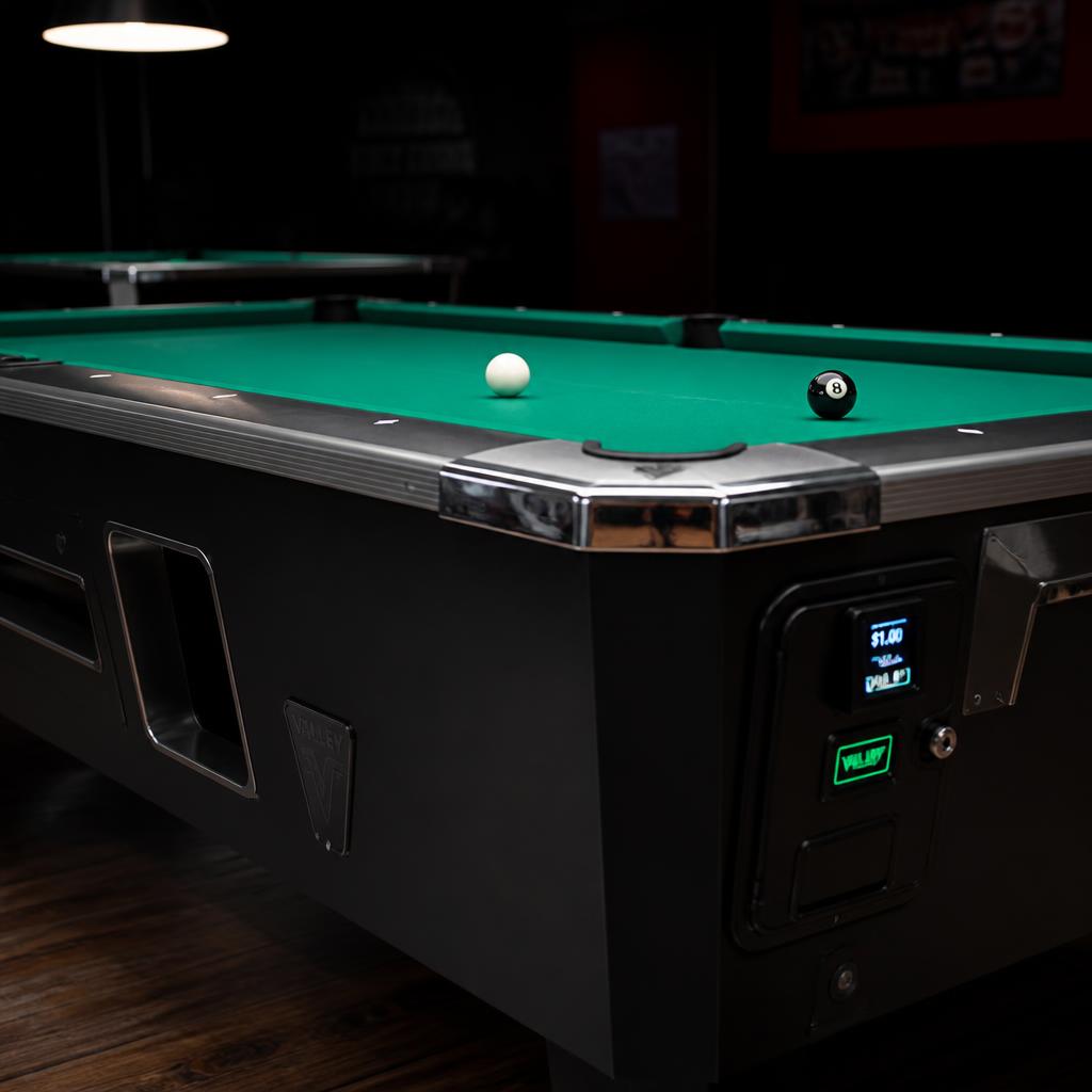 Freshly recovered commercial pool table with green felt and cue ball